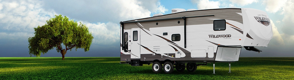 Fifth-wheel RV on grassy field